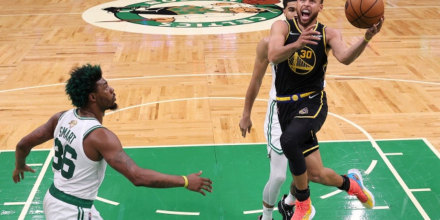 Golden State Warriors guard Stephen Curry goes up for a shot against the Celtics Wednesday, June 8, 2022, in Boston.