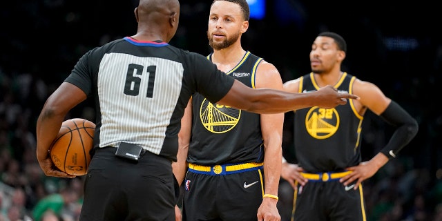 Golden State Warriors guard Stephen Curry (30) reacts to referee Courtney Kirkland (61) during the third quarter of Game 3 of basketball's NBA Finals against the Boston Celtics, Wednesday, June 8, 2022, in Boston.