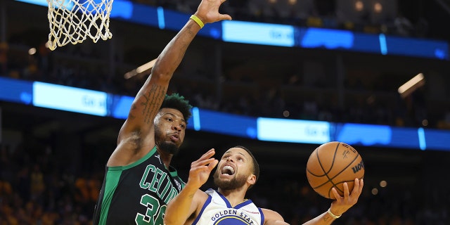 Golden State Warriors guard Stephen Curry (30) shoots against Boston Celtics guard Marcus Smart during the second half of Game 5 of basketball's NBA Finals in San Francisco, Monday, June 13, 2022.