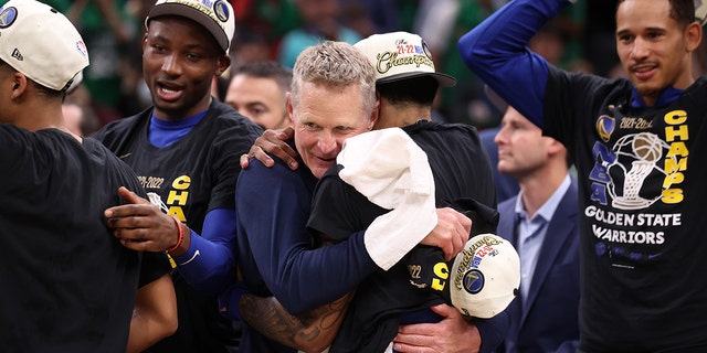 Head Coach Steve Kerr of the Golden State Warriors embraces Gary Payton II #0 of the Golden State Warriors after Game Six of the 2022 NBA Finals on June 16, 2022 at TD Garden in Boston, Massachusetts.