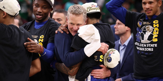 Head Coach Steve Kerr of the Golden State Warriors embraces Gary Payton II #0 of the Golden State Warriors after Game Six of the 2022 NBA Finals on June 16, 2022 at TD Garden in Boston, Massachusetts.