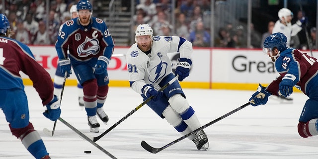 Tampa Bay Lightning center Steven Stamkos (91) controls the puck during the first period in Game 2 of the the team's NHL hockey Stanley Cup Final against the Colorado Avalanche, Saturday, June 18, 2022, in Denver. 