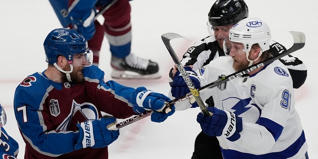 Tampa Bay Lightning center Steven Stamkos (91) clashes with Colorado Avalanche defenseman Devon Toews (7) during the first period in Game 2 of the NHL hockey Stanley Cup Final Saturday, June 18, 2022, in Denver. 