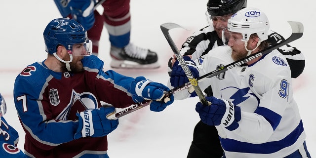 Tampa Bay Lightning center Steven Stamkos (91) clashes with Colorado Avalanche defenseman Devon Toews (7) during the first period in Game 2 of the NHL hockey Stanley Cup Final Saturday, June 18, 2022, in Denver. 