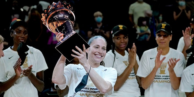Seattle Storm guard Sue Bird holds the championship trophy after the Commissioner's Cup game against the Connecticut Sun, Aug. 12, 2021, in Phoenix.