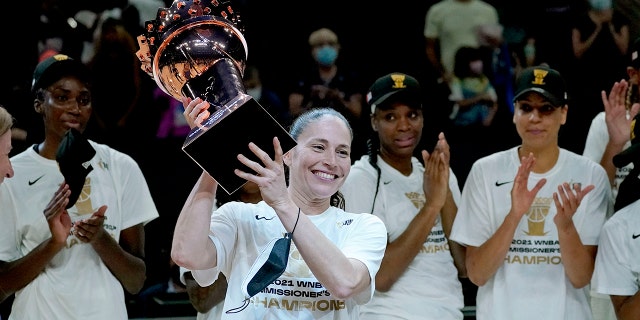 Seattle Storm guard Sue Bird holds the championship trophy after the Commissioner's Cup game against the Connecticut Sun, on Aug. 12, 2021, in Phoenix.