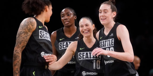 Seattle Storm guard Sue Bird (10) celebrates with teammates after scoring a 3-point goal during the final seconds of the second half of a WNBA basketball game against the New York Liberty, Sunday, June 19, 2022, in New York. 