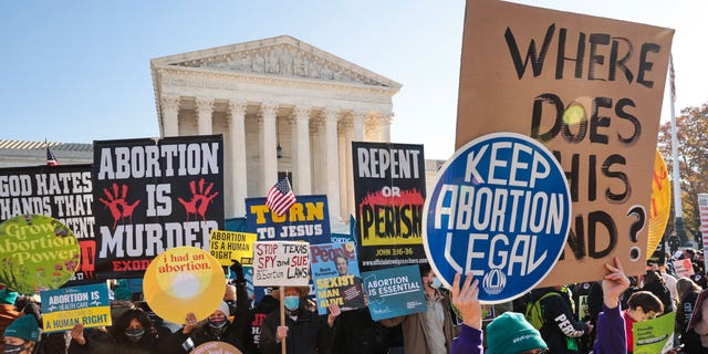 Demonstrators gather in front of the U.S. Supreme Court as the justices hear arguments in Dobbs v. Jackson Women's Health, a case about a Mississippi law that bans most abortions after 15 weeks, Dec. 1, 2021, in Washington, D.C. 