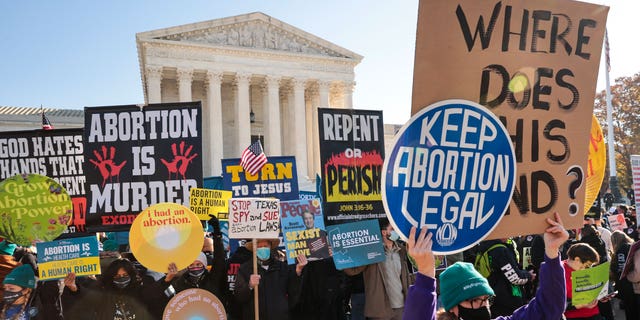 Demonstrators gather in front of the U.S. Supreme Court as the justices hear arguments in Dobbs v. Jackson Women's Health, a case about a Mississippi law that bans most abortions after 15 weeks, Dec. 1, 2021, in Washington, D.C. 