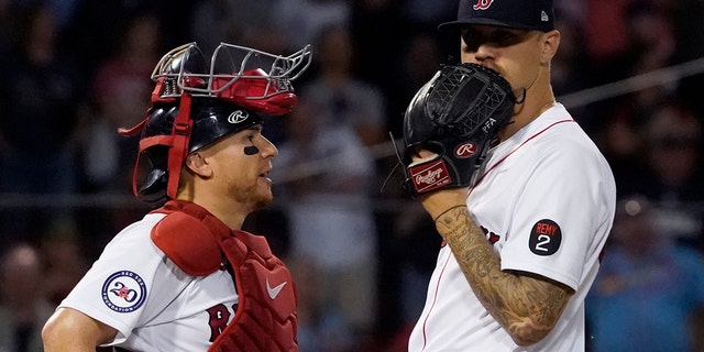 Red Sox pitcher Tanner Houck talks with catcher Christian Vazquez during the St. Louis Cardinals game at Fenway Park, Friday, June 17, 2022, in Boston.