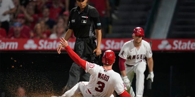 Taylor Ward (3) of the Los Angeles Angels slides home to score the sacrificial fly hit by David McKinnon during the fifth inning of a baseball game against the Kansas City Royals on Wednesday, June 22, 2022 in Anaheim, Calif. 