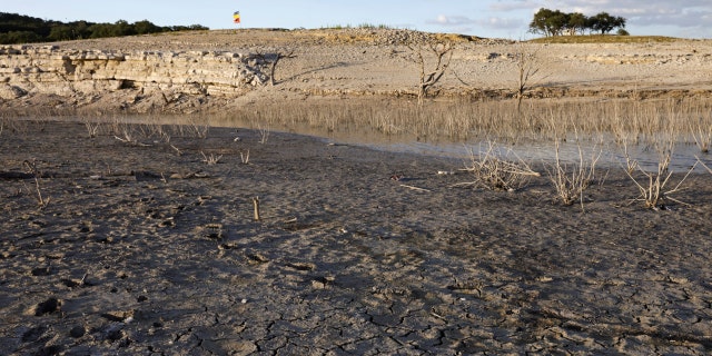 Cracks form on a dry lakebed at Medina Lake outside of San Antonio as majority of Texas experiences drought amid an extreme heat wave hitting the state, in Medina County, Texas, U.S., June 18, 2022. Picture taken June 18, 2022. 