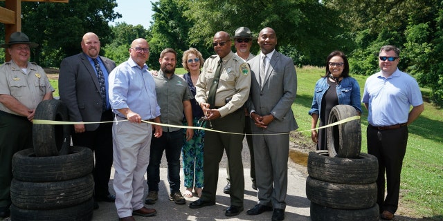 Tennessee officials, including Tennessee Department of Environment and Conservation Commissioner David Salyers and T.O. Fuller State Park Manager Jimmy Warren, gathered at the ribbon-cutting ceremony for T.O. Fuller State Park's new tire trail in Memphis, Tenn., on June 3, 2022. (Tennessee State Parks)