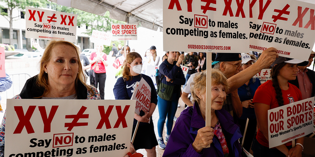 Demonstrators listen to the speaking program during an "Our Bodies, Our Sports" rally for the 50th anniversary of Title IX at Freedom Plaza on June 23, 2022 in Washington, D.C. 