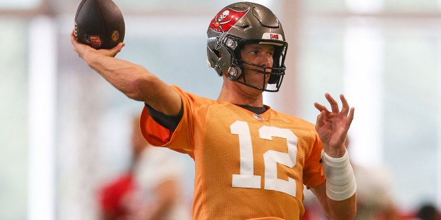Tampa Bay Buccaneers quarterback Tom Brady, 12, participates in a mandatory mini-camp at the AdventHealth training center.