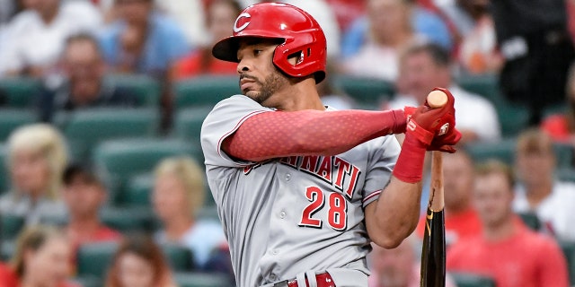 Cincinnati Reds left fielder Tommy Pham swings and misses during a game against the Cardinals June 10, 2022, at Busch Stadium in St. Louis.
