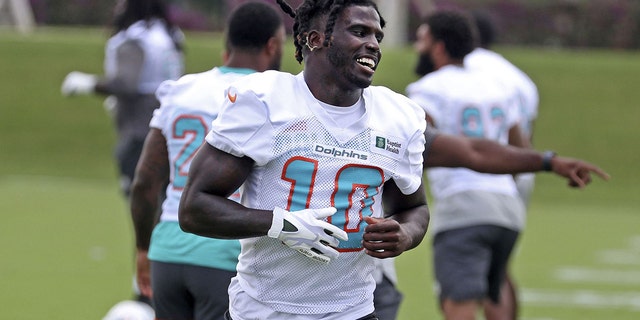 Miami Dolphins wide receiver Tyreek Hill, #10, warms up during OTA practice on Tuesday, May 17, 2022, at the team's training facility in Miami Gardens, Florida.
