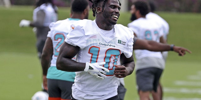 Miami Dolphins wide receiver Tyreek Hill, #10, warms up during OTA practice on Tuesday, May 17, 2022, at the team's training facility in Miami Gardens, Florida.