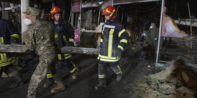 Ukrainian State Emergency Service firefighters are seen on Tuesday, June 28, working in the rubble of the mall.