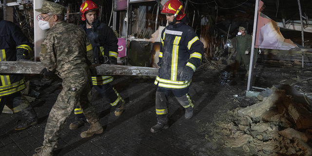 Ukrainian State Emergency Service firefighters are seen on Tuesday, June 28, working in the rubble of the mall.