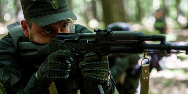 A soldier of the National Guard of Ukraine holds a weapon during a training in tactical medicine, as the Russian invasion in Ukraine continues, in the Transcarpathian region, Ukraine, May 19, 2022. 