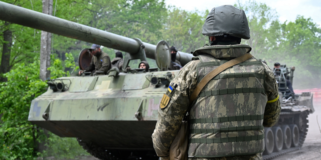 A Ukrainian serviceman looks at a self-propelled howitzer on a road in the Kharkiv region on May 17.