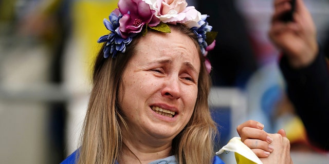 A Ukraine fan in the stands sheds a tear at a World Cup 2022 qualifying playoff match between Wales and Ukraine at Cardiff City Stadium, in Cardiff, Wales, Sunday, June 5, 2022.