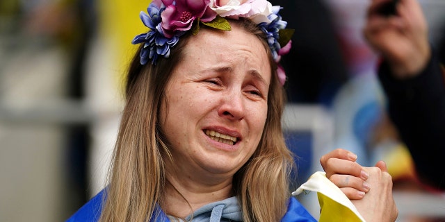A Ukraine fan in the stands sheds a tear at a World Cup 2022 qualifying playoff match between Wales and Ukraine at Cardiff City Stadium, in Cardiff, Wales, Sunday, June 5, 2022.