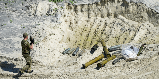 Ukrainian servicemen prepare unexploded Russian ammunition for destruction in the outskirts of Kyiv, Ukraine, on Wednesday, June 1.