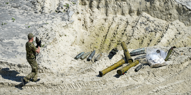 Ukrainian servicemen prepare unexploded Russian ammunition for destruction in the outskirts of Kyiv, Ukraine, on Wednesday, June 1.