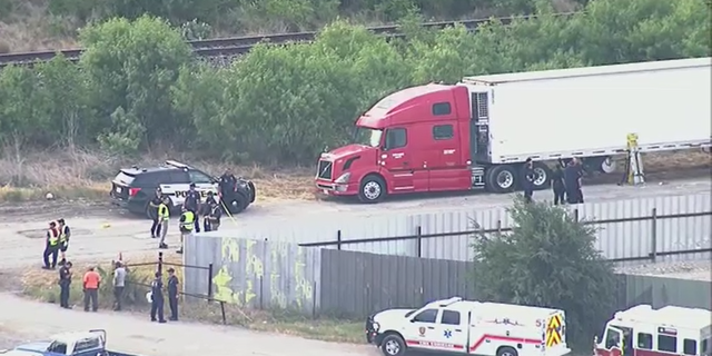 Authorities at the scene where more than 40 migrants were found dead Monday inside a large truck in San Antonio, Texas.