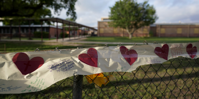 On Friday, June 3rd, a banner heart is hanging on the fence of Rob Elementary School where I boarded.