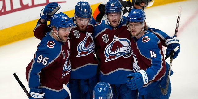 Colorado Avalanche right wing Valeri Nichushkin (13) celebrates his goal against the Tampa Bay Lightning with right wing Mikko Rantanen (96) defenseman Josh Manson (42) and defenseman Bowen Byram (4) during the second period in Game 2 of the NHL hockey Stanley Cup Final, Saturday, June 18, 2022, in Denver.