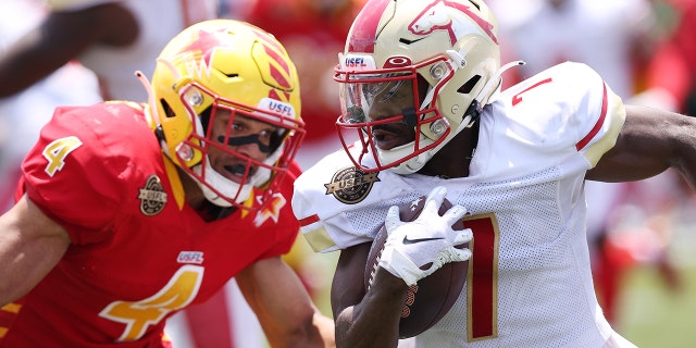 Victor Bolden Jr. #7 of Birmingham Stallions runs the ball as LaDarius Wiley #4 of Philadelphia Stars defends in the third quarter of the game at Protective Stadium on May 15, 2022 in Birmingham, Alabama.