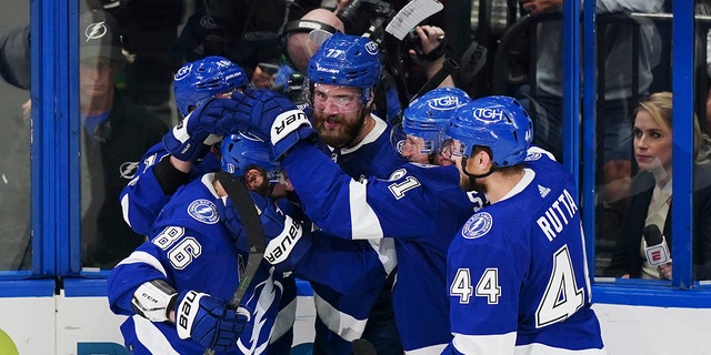 Tampa Bay Lightning defenseman Victor Hedman, center, is congratulated by teammates after scoring on Colorado Avalanche goaltender Darcy Kuemper during the second period of Game 4 of the NHL hockey Stanley Cup Finals on Wednesday, June 22, 2022, in Tampa, Fla. 