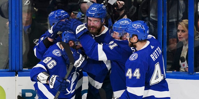 Tampa Bay Lightning defenseman Victor Hedman, center, is congratulated by teammates after scoring on Colorado Avalanche goaltender Darcy Kuemper during the second period of Game 4 of the NHL hockey Stanley Cup Finals on Wednesday, June 22, 2022, in Tampa, Fla. 