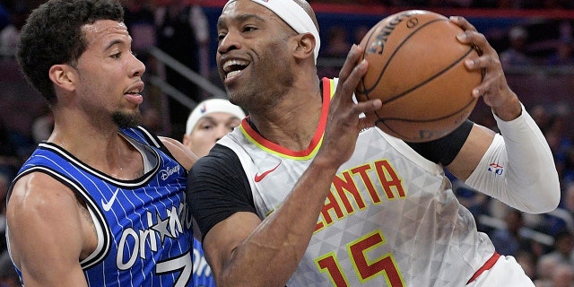 FILE - Atlanta Hawks forward Vince Carter (15) drives to the basket against Orlando Magic guard Michael Carter-Williams (7) during the first half of an NBA basketball game in Orlando, Fla., Friday, April 5, 2019.