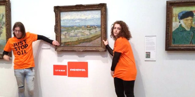 Supporters of "Just Stop Oil" glue themselves to the frame of a Vincent van Gogh painting. 