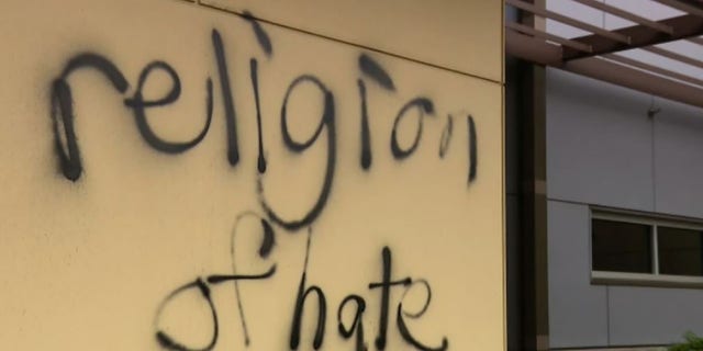 A message spray-painted in June on the wall of St. Louise Catholic Church in Bellevue, Washington, reads, "religion of hate."