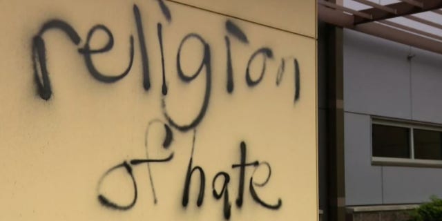 A message spray-painted in June on the wall of St. Louise Catholic Church in Bellevue, Washington, reads, "religion of hate."