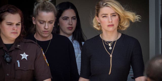 Actress Amber Heard, right, and her sister Whitney Heard, second from left, leave the Fairfax County Courthouse on June 1, 2022 in Fairfax, Virginia.