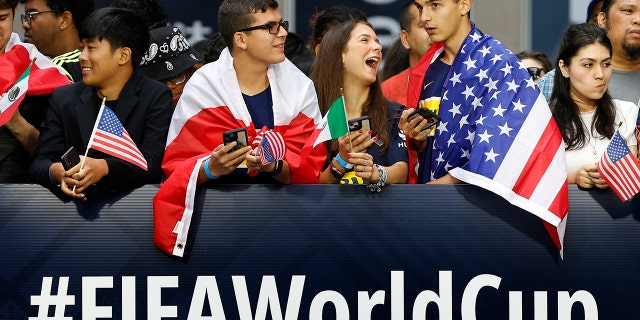 Fans wait along 6th Avenue for FIFA's announcement of the host cities for the 2026 World Cup, Thursday, June 16, 2022, in New York.