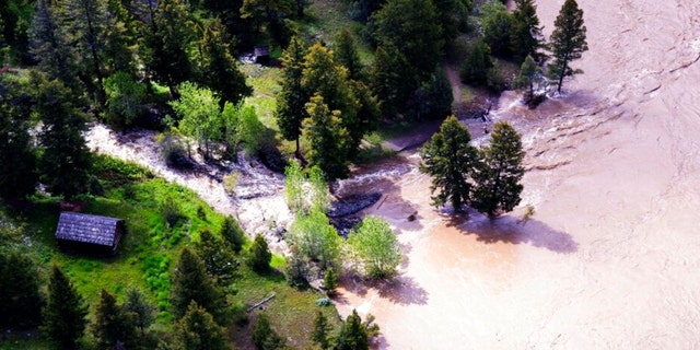 This aerial image provided by the National Park Service shows a Low Blacktail Patrol Cabin washed up in Yellowstone National Park on Monday, June 13, 2022. 