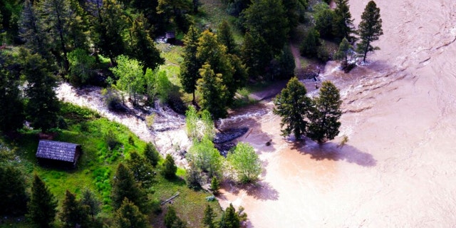 This aerial photo provided by the National Park Service shows the Lower Blacktail Patrol Cabin washed away in Yellowstone National Park on Monday, June 13, 2022. 