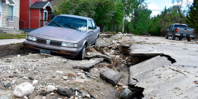 Flood damage is seen along a street Tuesday, June 14, 2022, in Red Lodge, Mont. Residents were cleaning up after record floods in southern Montana this week. 