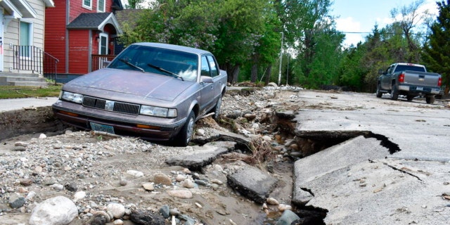 Flood damage is seen along a street Tuesday, June 14, 2022, in Red Lodge, Mont. Residents were cleaning up after record floods in southern Montana this week. 