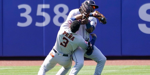 Houston Astros' Jeremy Pena (3) and Yordan Alvarez collide catching a fly ball by New York Mets' Dominic Smith during the eighth inning of a baseball game, Wednesday, June 29, 2022, in New York. 