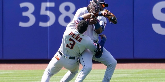 Houston Astros' Jeremy Pena (3) and Yordan Alvarez collide catching a fly ball by New York Mets' Dominic Smith during the eighth inning of a baseball game, Wednesday, June 29, 2022, in New York.