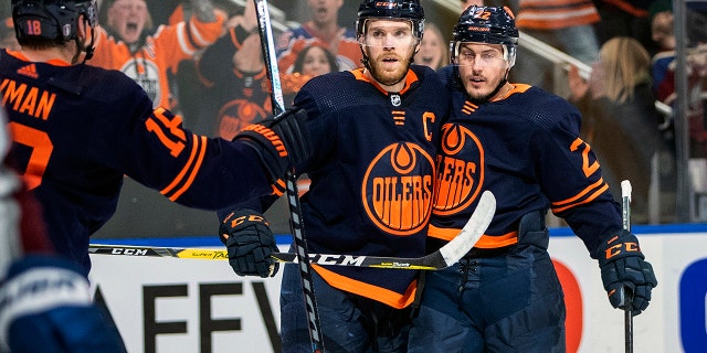 Edmonton Oilers' Zach Hyman (18), Connor McDavid (97) and Tyson Barrie (22) celebrate a goal against the Colorado Avalanche during second period NHL hockey conference finals action in Edmonton, Alberta, on Monday, June 6, 2022.