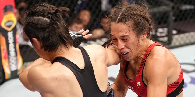 Zhang Weili of China knocks out Joanna Jedrzejczyk of Poland with a spinning back fist in a flyweight fight during the UFC 275 event at Singapore Indoor Stadium June 12, 2022, in Singapore.